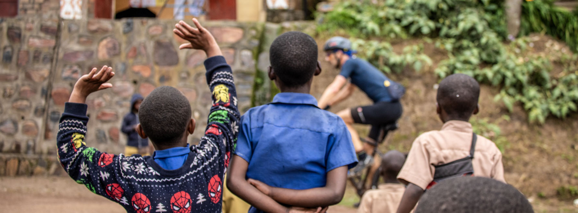 Uganda-kids-cheering-at-cycllist Ugandan kids are cheering at a passing cyclist